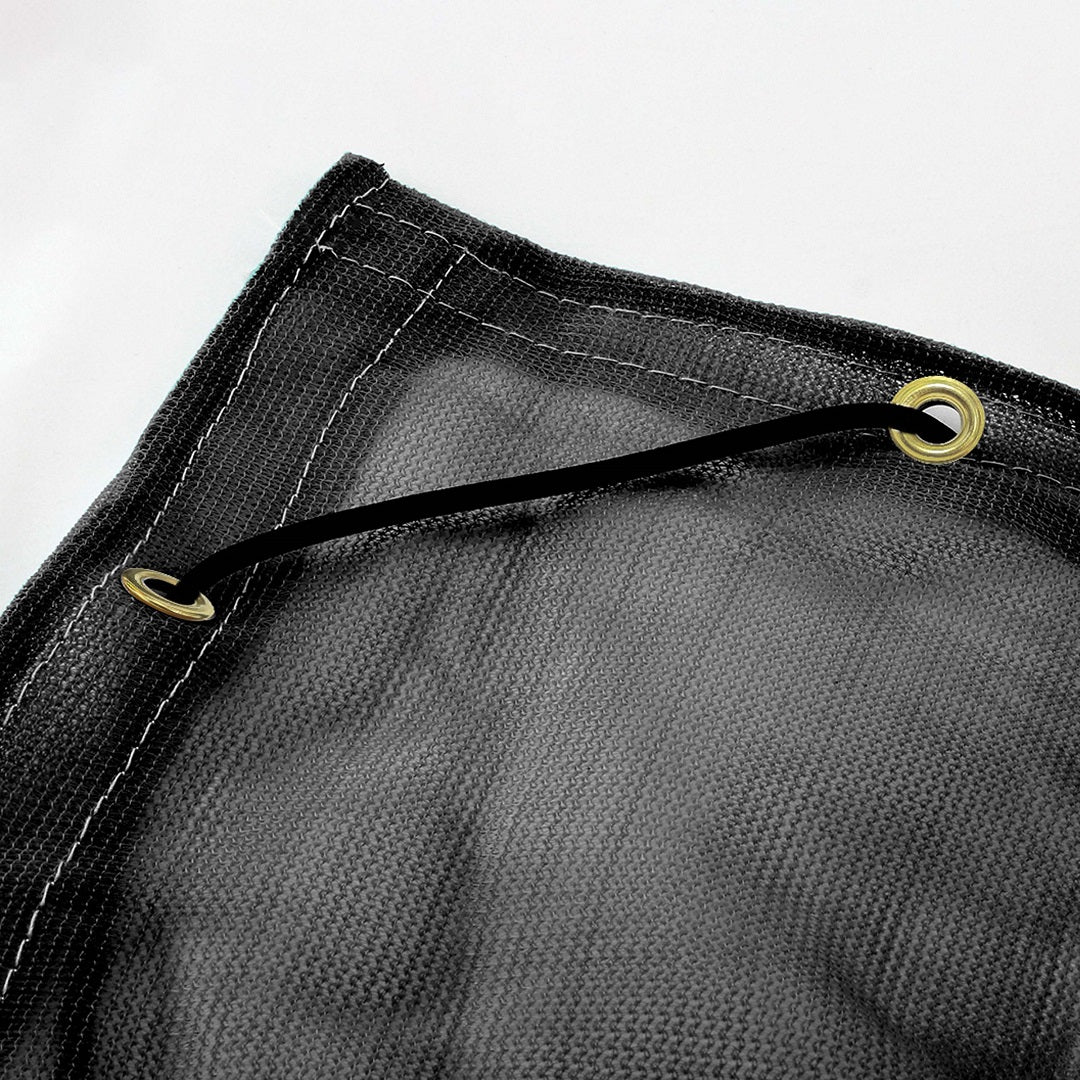 Close-up of a Cargo Mate Cargo Covers - 1.6x2.5m black mesh tarp corner made from high-density polyethylene with reinforced white-stitched edges. Two metal grommets are linked by an elastic shock cord. The UV-protected tarp is set against a plain light background.