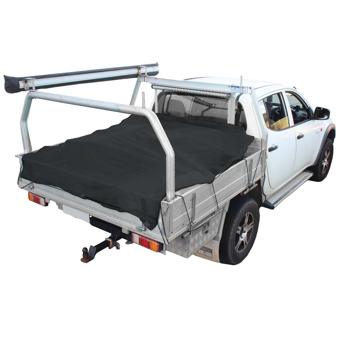 A white pickup truck, covered by a black Cargo Mate 1.6x2.5m tarp with UV protection, features a metal utility rack and towing hitch. The image focuses on the rear, highlighting the elastic shock cord securing the cargo cover.