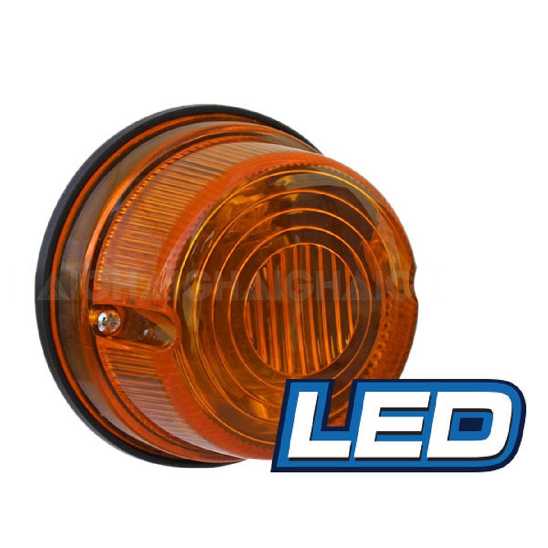 The Eagle Eye LED Round Trailer Lamp features an amber light with a ribbed circular surface and black base, ideal for 12V use. The word "LED" appears in bold blue and white lettering at the bottom right, highlighting its function as an expert amber indicator.