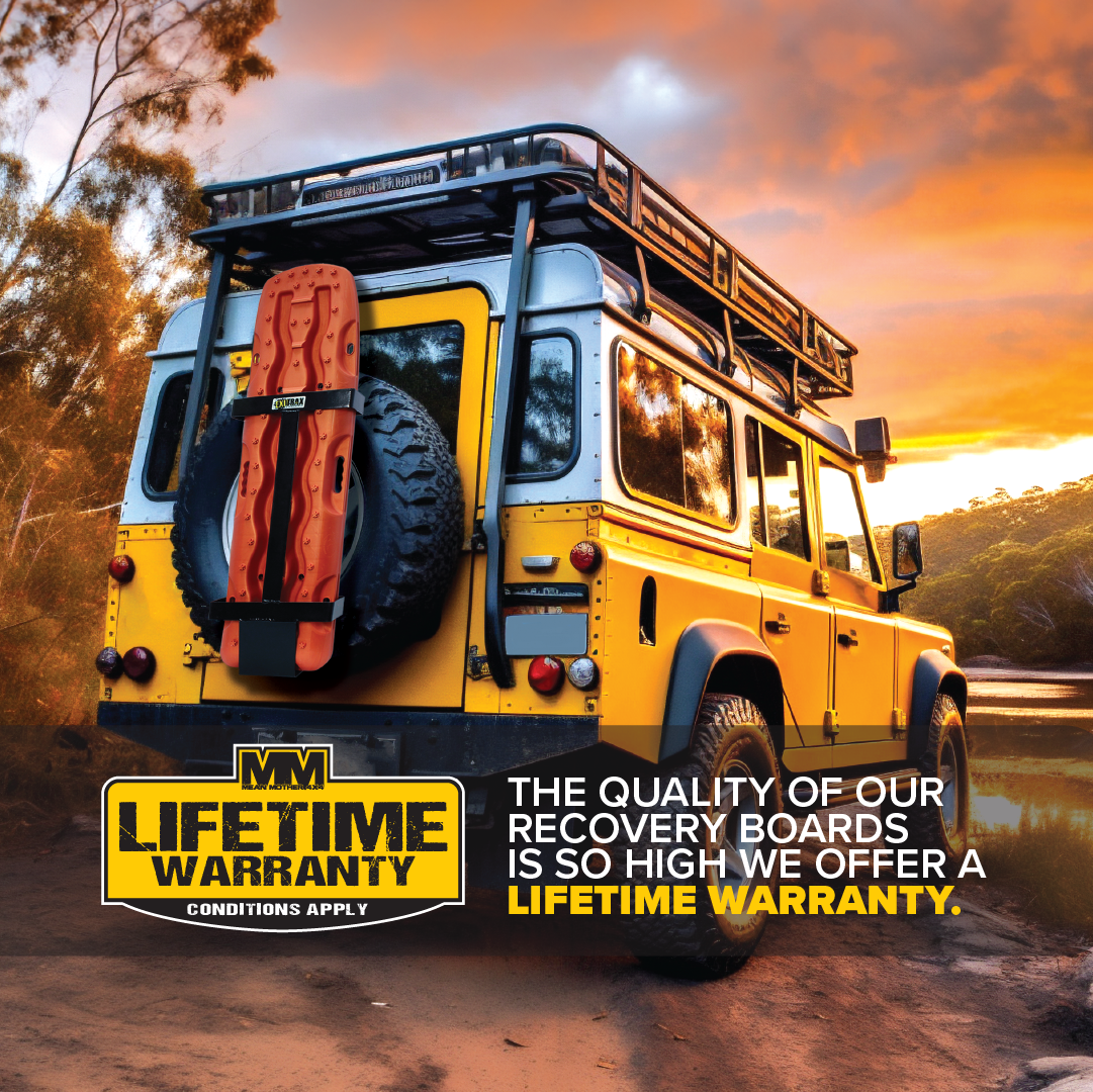A yellow off-road vehicle with Exitrax Recovery Boards 1110 Series in Metallic Sunrise Red mounted on the back is parked near a river at sunset. Text reads, "Our boards are so reliable, they come with a lifetime warranty.