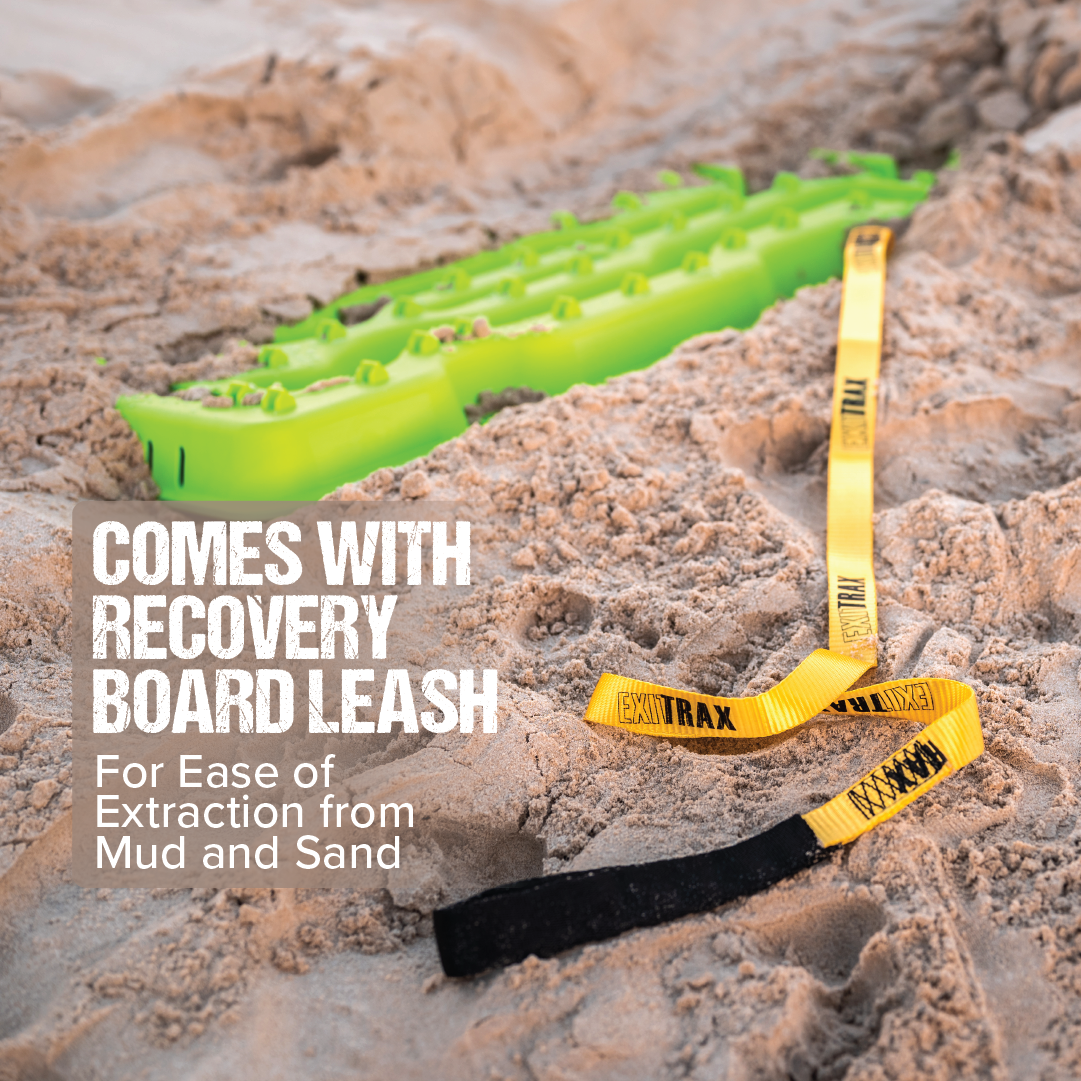 On sand sits an Exitrax Recovery Board 1110 Series, black. Yellow and black leashes are visible. Text reads: "Includes recovery board leash for seamless extraction from mud and sand, ideal for 4x4 recovery adventures.