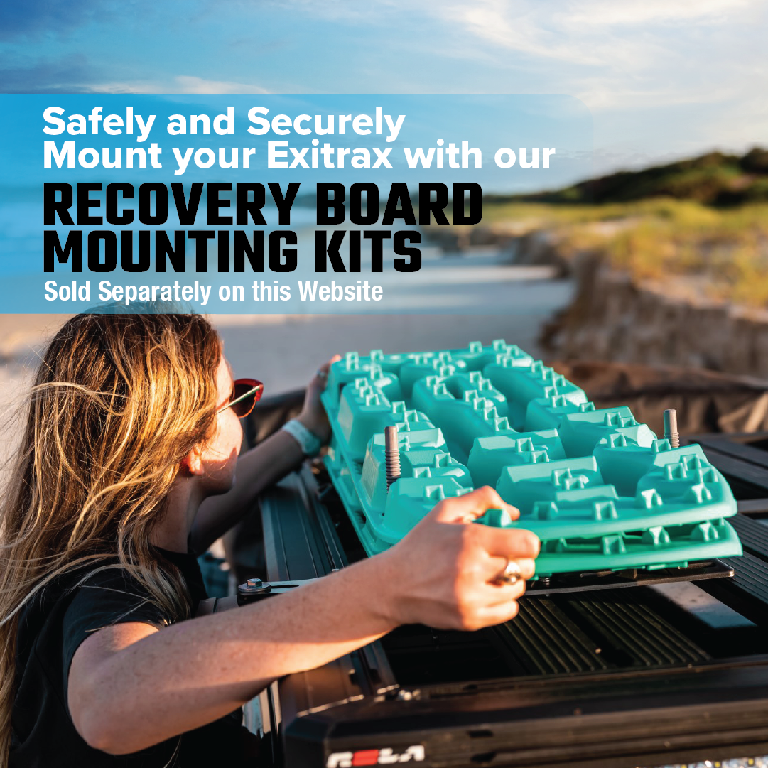A person in sunglasses secures an Exitrax Recovery Board 1110 Series - Black with Mounts onto a vehicle roof amidst coastal landscapes and dunes, under a blue sky. Perfect for 4x4 recovery adventures. Discover the Exitrax Recovery Board Mounting Bundle on our site.