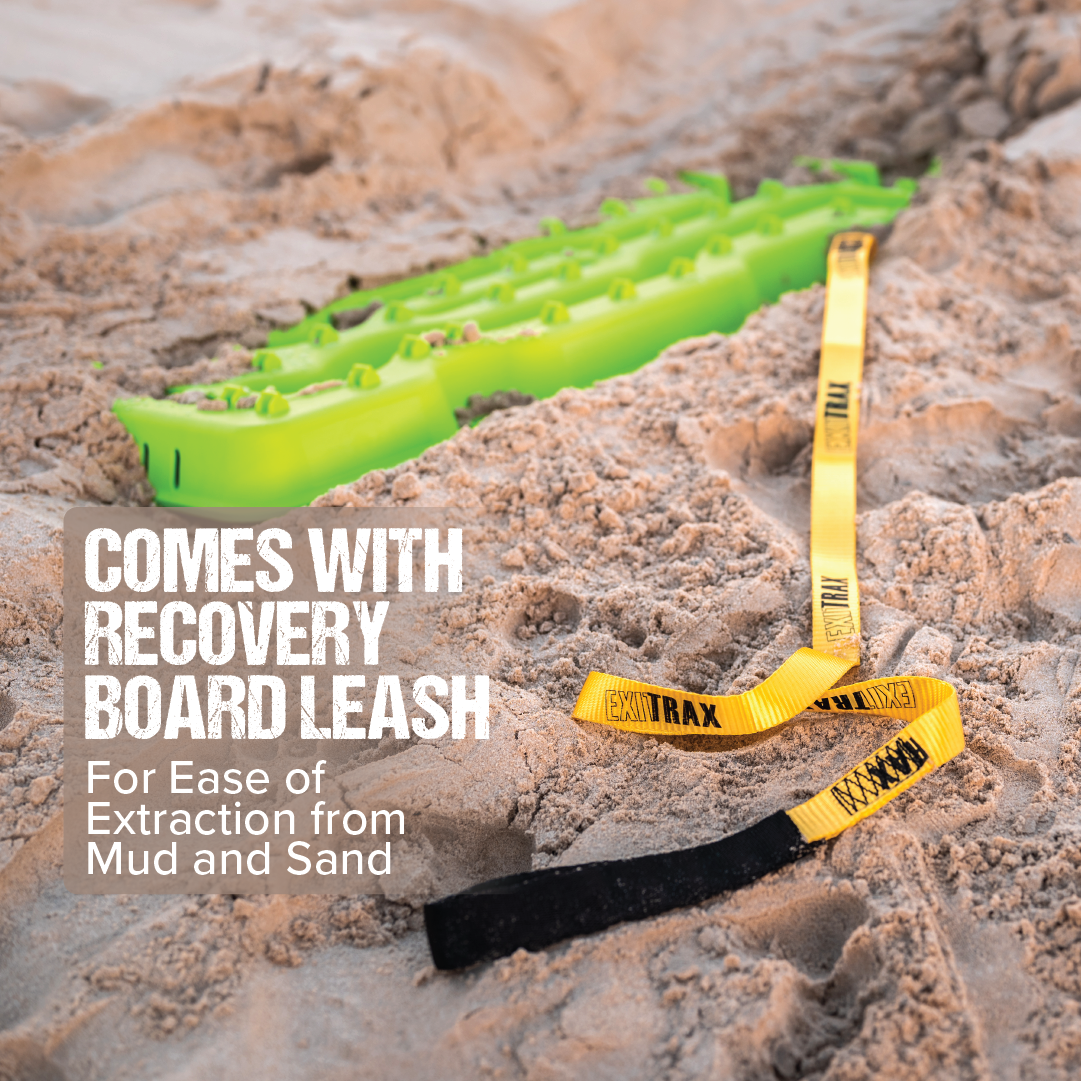 A bright green Exitrax Recovery Board 930 Series lies partially buried in sand with an attached yellow and black leash. The text overlay reads "COMES WITH RECOVERY BOARD LEASH For Ease of Extraction from Mud and Sand. Reduces Wheel Spin.