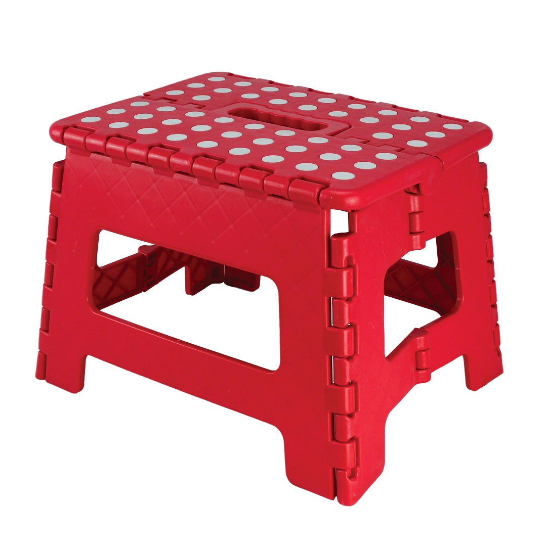 The Explore Folding Step Stool is a red plastic step stool designed with white polka dots on the top surface, offering a non-slip grip and equipped with a handle for convenient carrying. An ideal portable seat for camping adventures.