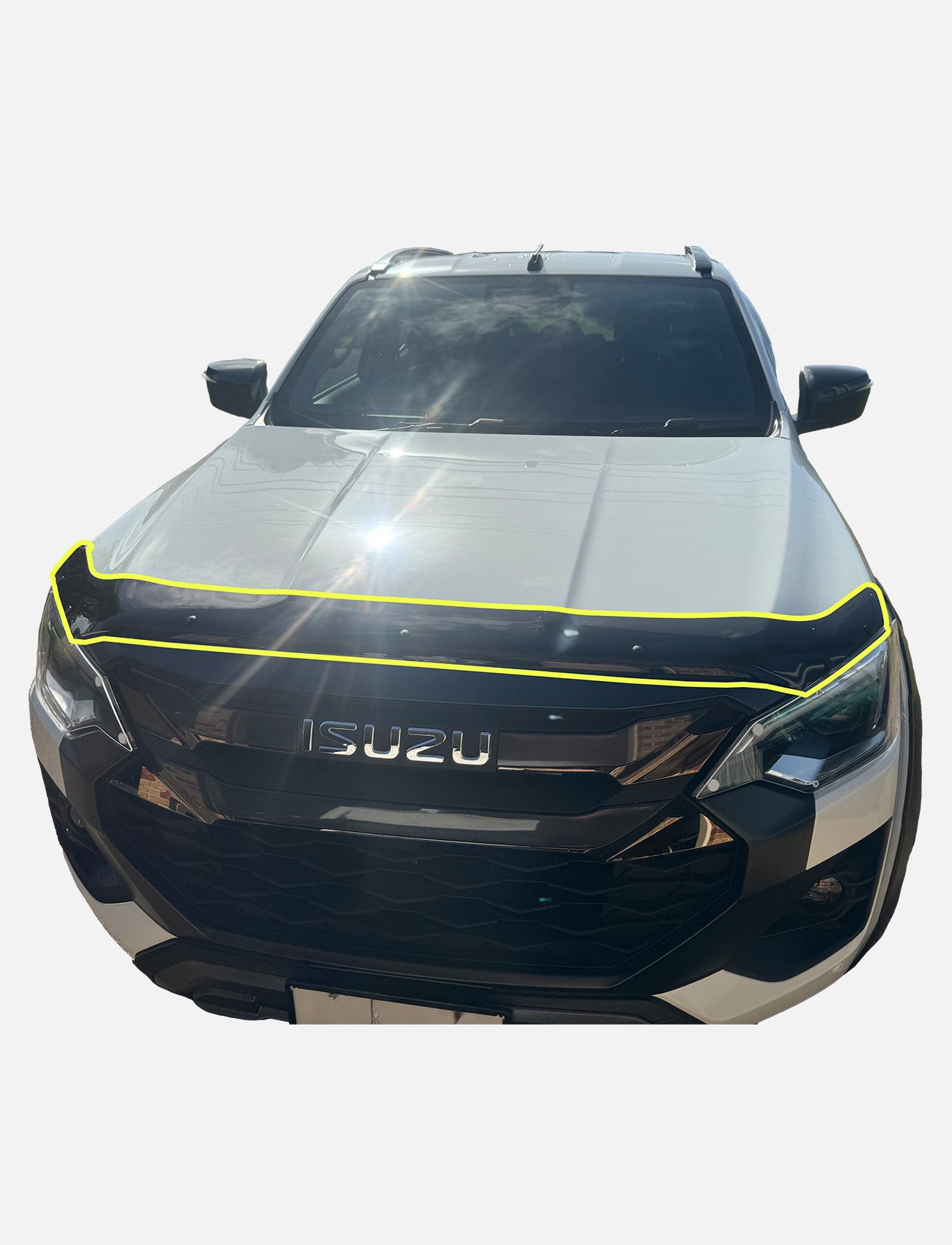 Front view of a white Isuzu D-Max (04/2024-On>) with a Sunland Protective Plastics Bonnet Protector in Dark Tint (I150BT), highlighted by a yellow outline, parked outdoors under sunlight.