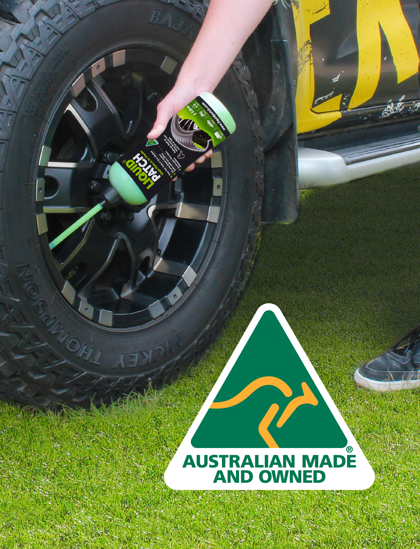 A person applies Liquid Patch Tyre Puncture Repair - 1L to a vehicle tire on grass, utilizing its dual-use tube and tyre sealant for automatic puncture protection, accompanied by an "Australian Made and Owned" logo with a stylized kangaroo.