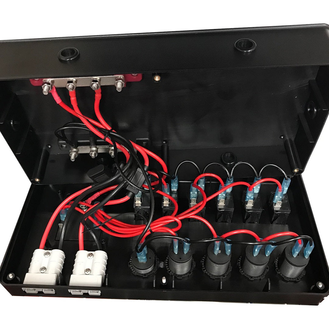 An open black electronic enclosure from Mean Mother reveals an array of internal components, including several red and black wires connected to terminals, fuses, and circuit connectors. The arrangement suggests this could be a Mean Mother 12V Power Control Box setup commonly used in canopies and caravans.