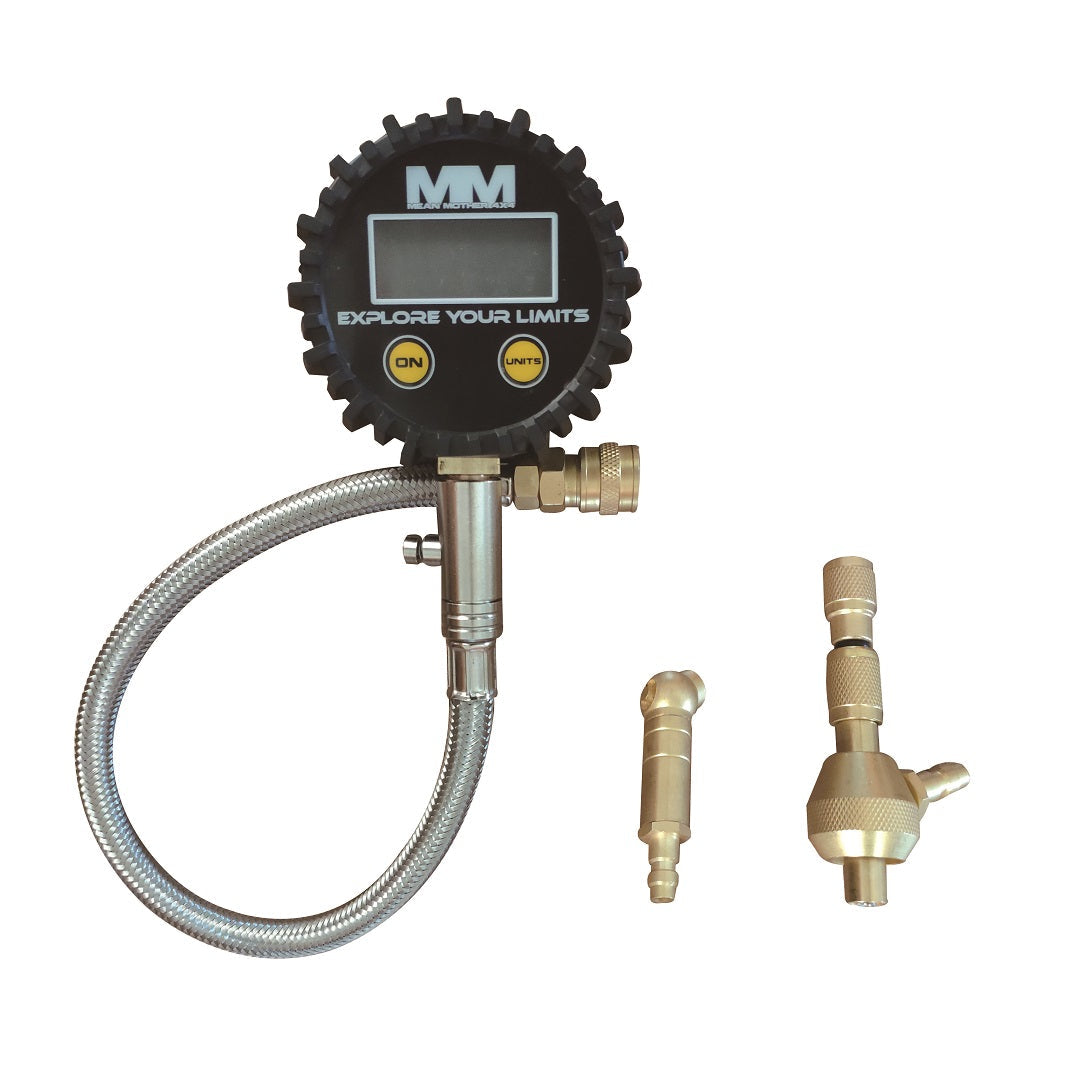 The Mean Mother 4x4 Digital Tyre Deflator & Gauge Kit features a black rubber casing, silver flexible hose, and two brass fittings. Ideal for beach driving, it includes a digital display with "On" and "Unit" buttons. The screen reads "EXPLORE YOUR LIMITS.