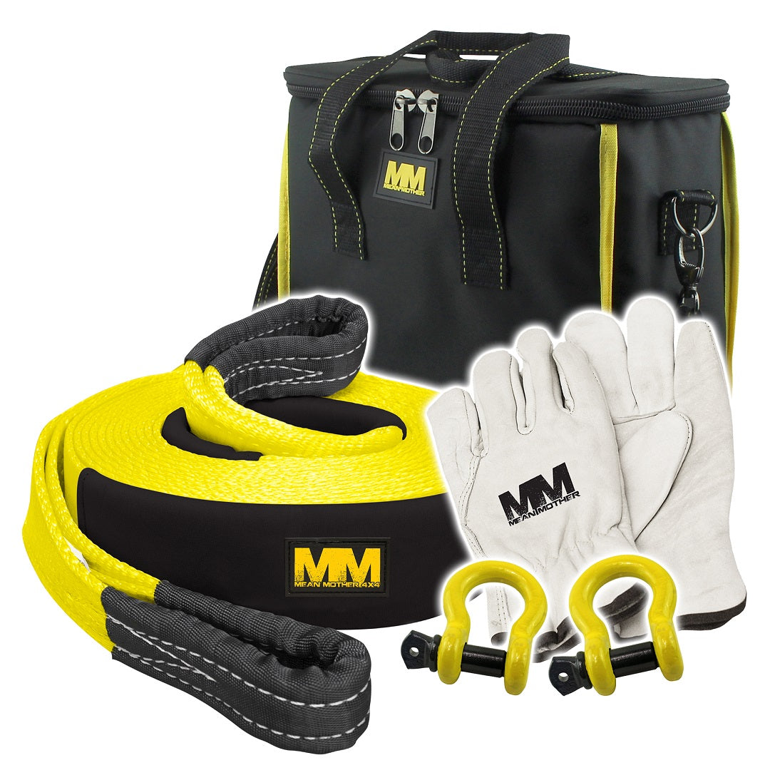 Introducing the Mean Mother 4x4's 4WD Recovery Kit 11,000kg 5pc: this off-road recovery kit features a sturdy snatch strap, a sleek black and yellow carrying bag, two resilient yellow bow shackles (D-rings), and a pair of white gloves. Each component is adorned with our distinctive black and yellow logo.