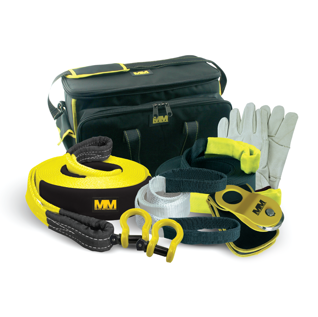 The Mean Mother 4x4 Recovery Kit 11,000kg 8pc is essential for any off-road adventure, featuring a stylish black and yellow bag, a heavy-duty snatch strap, black and white straps with hooks, grey gloves, and a sleek pulley in matching colors.