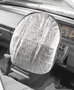 A Sunland-Protection Steering Wheel Cover, reflecting silver, protects your steering wheel as the dashboard, speedometer, and fabric seat emphasize the importance of preserving your vehicle's interior.