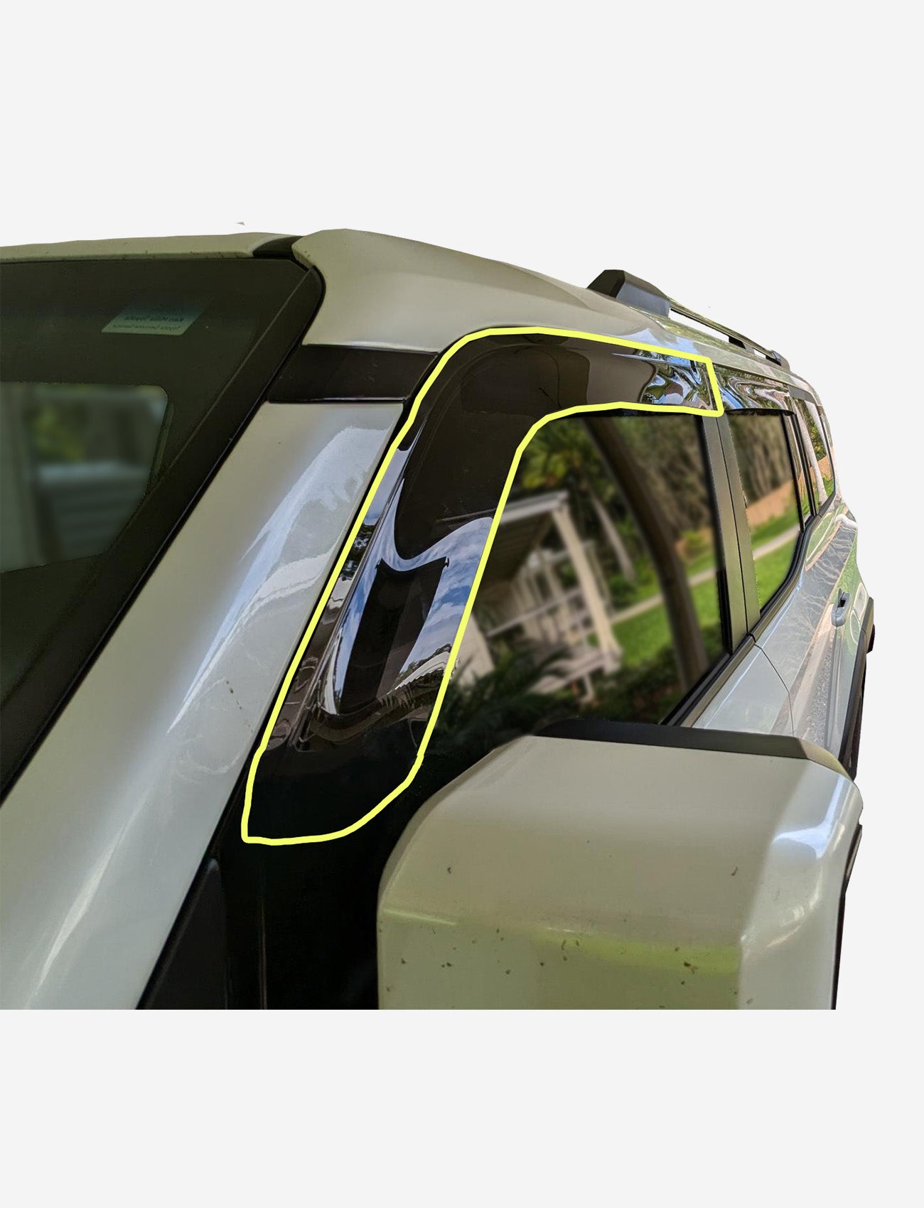 Close-up of a Toyota Prado 250 Series fitted with a Sunland Protective Plastics Slimline Passenger Weathershield in dark tint, custom-moulded for UV stability. The window reflects greenery and a house in the background.