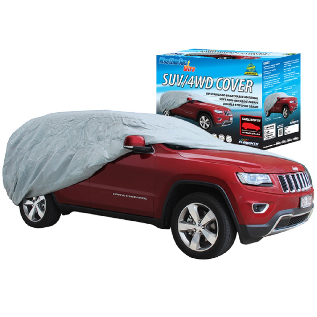 A red SUV is partially covered by a Weather-Tec Ultra gray SUV car cover from WeatherTec, providing UV protection. The packaging box positioned behind the vehicle displays an illustration of a fully covered SUV along with product details for the Weather-Tec Ultra, suitable for large 4WD/SUVs ranging from 4.66m to 5.12m.
