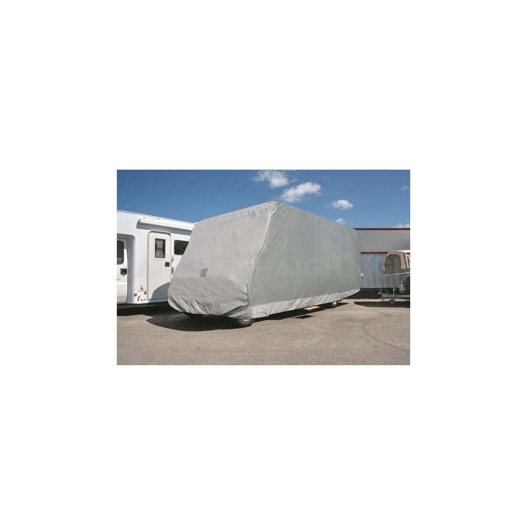 Under a clear blue sky, a Class C Motorhome covered in a Prestige UV-stabilized, waterproof cover, measuring 7.9m to 8.8m, is parked in an open area, with another vehicle partially visible beside it.