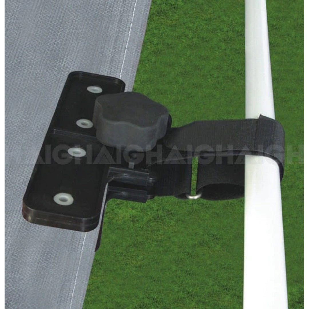 The Explore Caravan Awning Tensioner features a black clamp with an adjustable knob and secures a grey tarp to a white pole using a Velcro strap for rust-proof durability, providing awning protection against the elements on a green grass background.