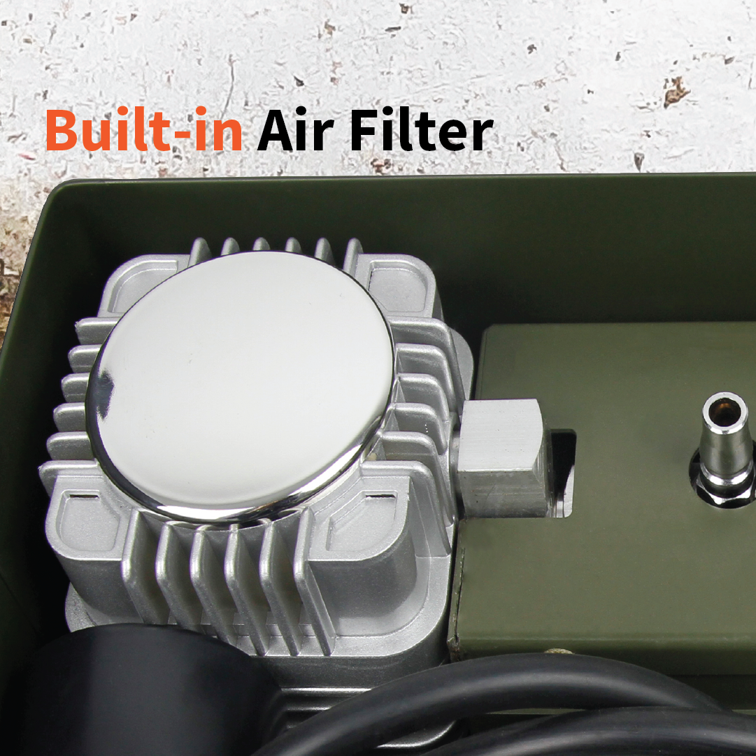 Close-up of the Dr Air Ammo Box Air Compressor, highlighting its sleek, metallic component with a smooth, reflective surface. Text above reads "Built-in Air Filter" in bold black and orange letters. Set against a light, textured background, this unit is designed with heavy-duty ammo housing for military-tough reliability.