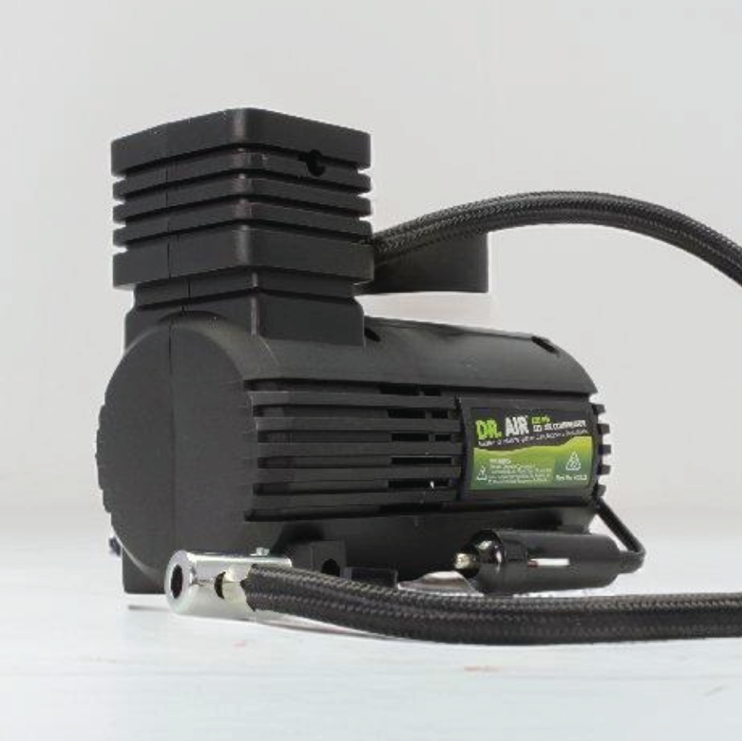 A Dr Air 12V Air Compressor 250psi, featuring a pressure gauge, a flexible hose, and adorned with a green label on its black body, is set against a plain white background.