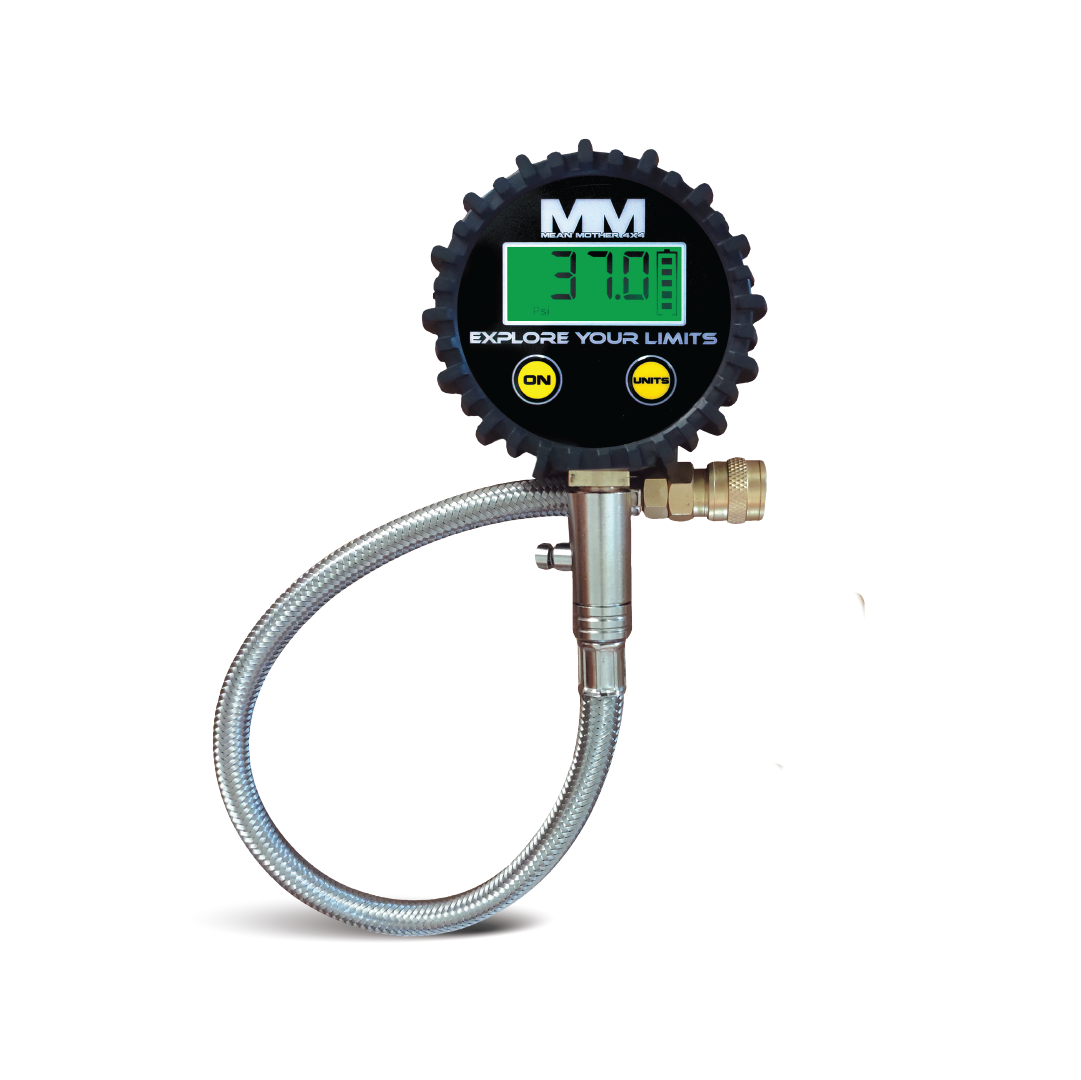 The Mean Mother 4x4 Digital Tyre Deflator & Gauge Kit features a flexible metal hose and a round black display reading "37.0," ideal for beach driving. It includes two yellow buttons, "ON" and "UNIT," with the logo "MM Explore Your Limits.