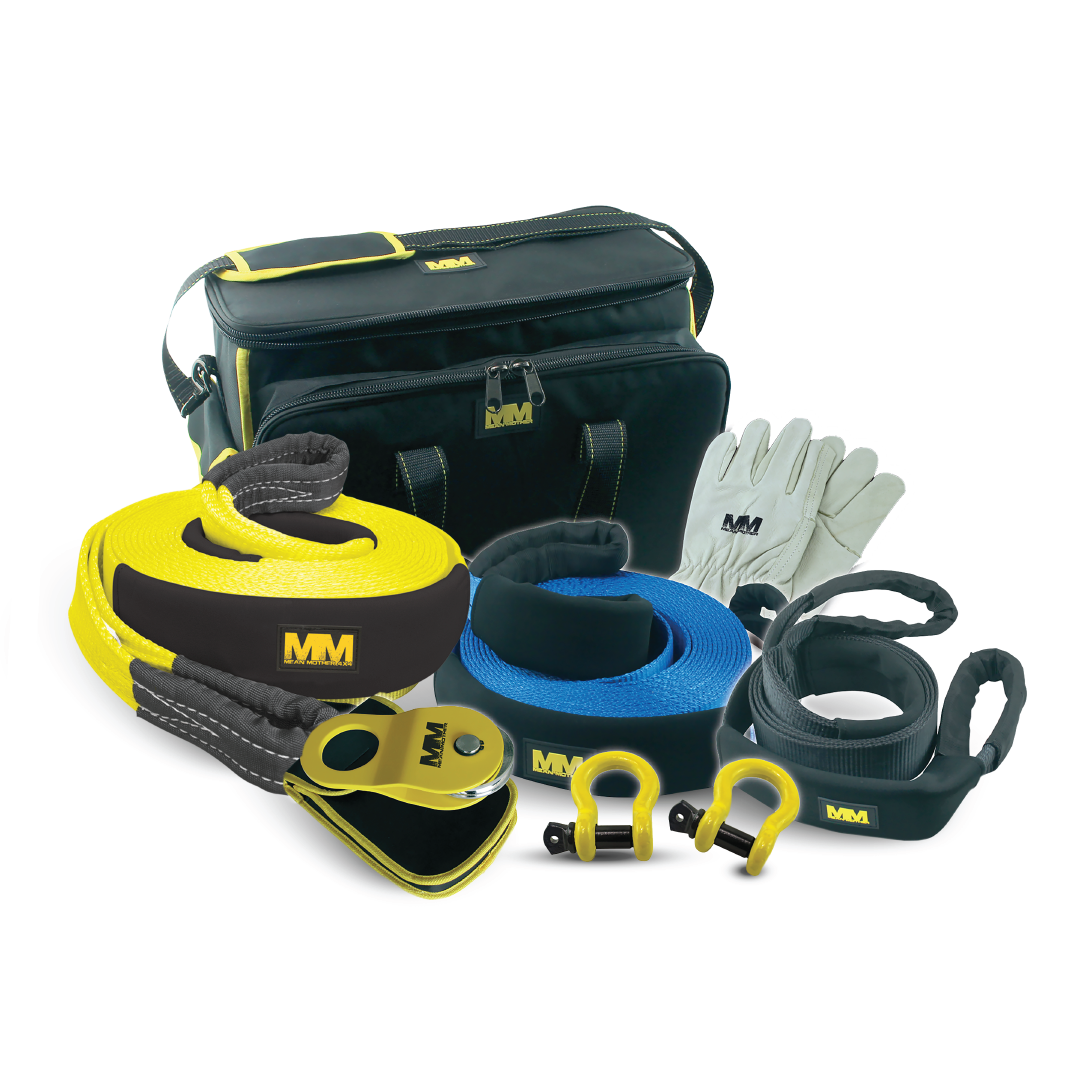 Meet the Mean Mother 4x4 Recovery Kit 8,000kg 8pc | Premium: a rugged black and yellow bag with two coiled straps (yellow and blue), heavy-duty bow shackles, gloves, a snatch block, and protective sleeves. Crafted for precision and strength in every adventure.