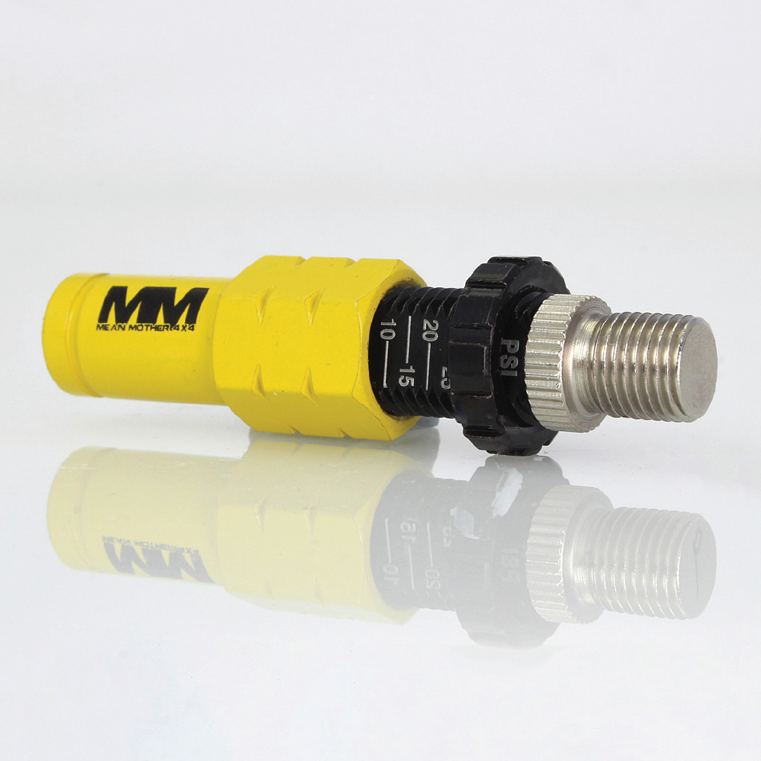 A yellow and black torque tool with an adjustable dial and metal threaded end, perfect for off-road enthusiasts. The main body features branding initials, reflected on the white surface, making these Mean Mother 4x4 Tyre Deflators - 4 Pack an ideal companion for 4WD adventures involving precise adjustments like tire deflation.