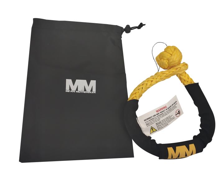 A yellow UHMPE synthetic rope shackle with black protective covering is placed next to a black drawstring bag featuring the Mean Mother 4x4 "MM" logo. This crucial component of the Soft Shackle & Snatch Ring Bundle includes a label highlighting safety warnings, guaranteeing dependable use in all your off-road adventures.
