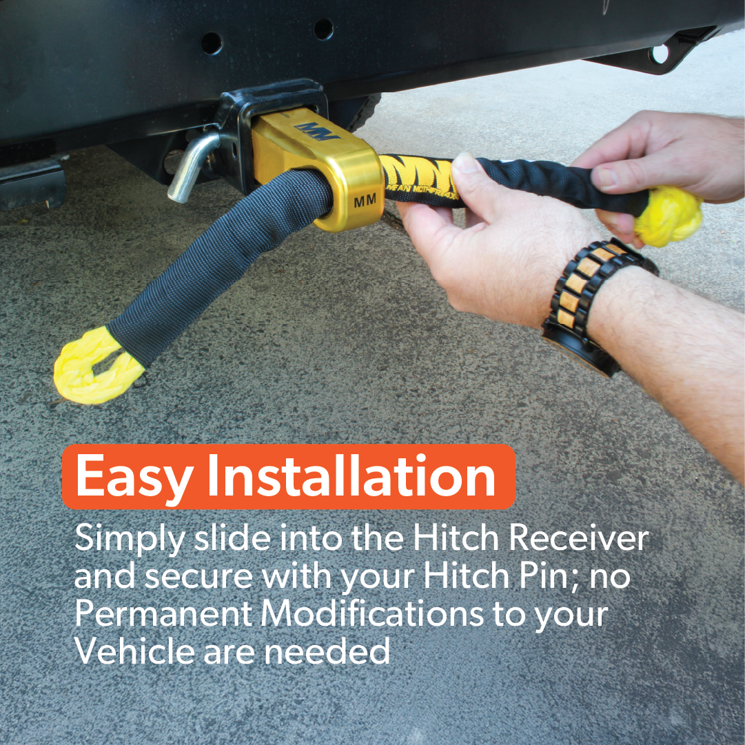 A person fits the Mean Mother 4x4 Recovery Hitch into a vehicle's tow hitch receiver. Text overlay: “Quick install—just slide the Recovery Hitch in and secure with your hitch pin; no permanent changes required.”.