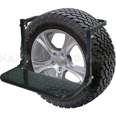 An image showing the Mean Mother 4x4 Wheel Step attached to a tire. The step stool is secured to the tire via a sturdy metal frame, providing a reliable platform for 4WD roof cleaning or easy access to elevated vehicle parts. The tire features a rugged, all-terrain tread for enhanced durability and performance.