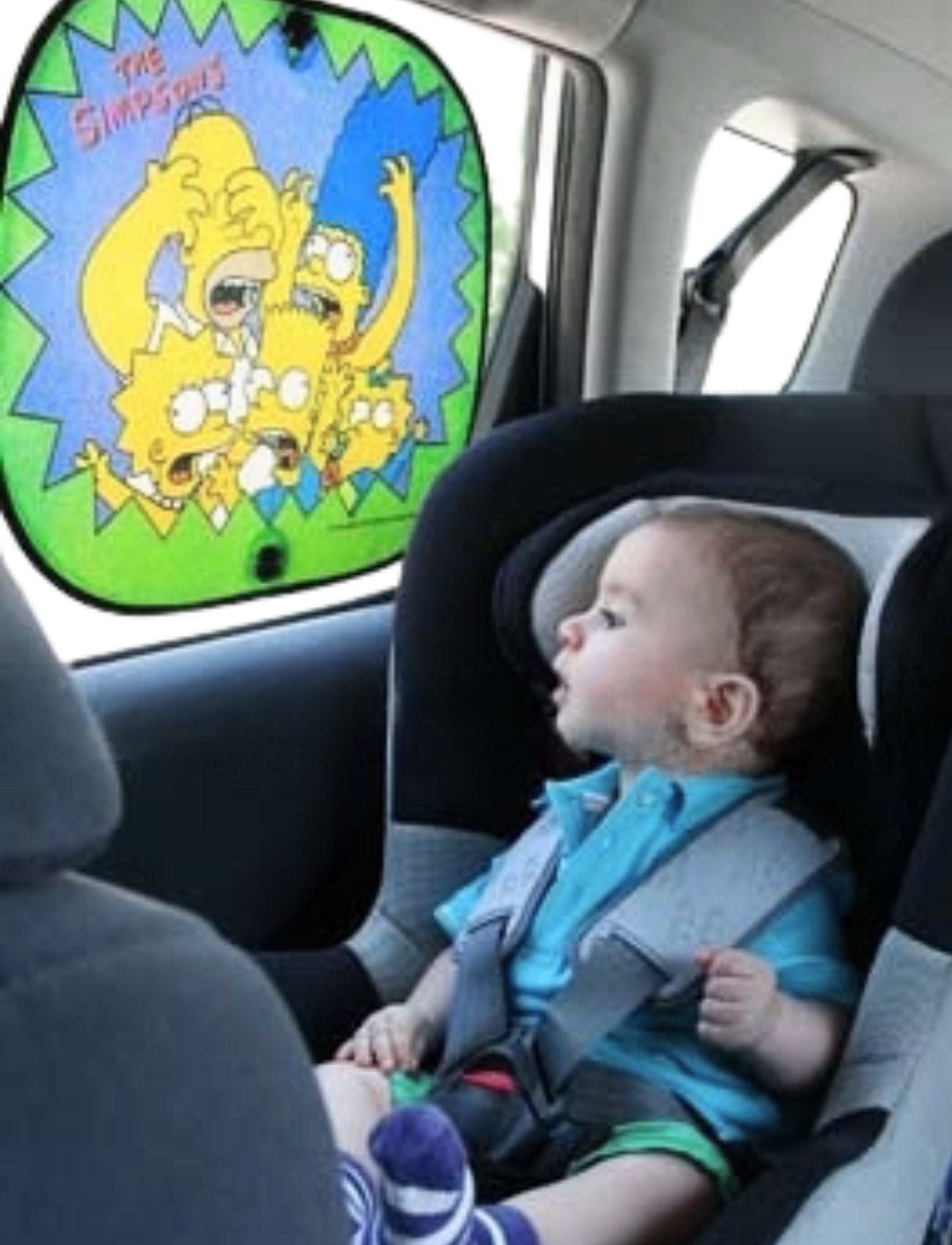 A baby enjoys sitting in a car seat, looking at Sunland-Protection’s Car Sun Shade Simpsons Side. It adds vibrant color with fun illustrations of The Simpsons family on the window.