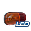 The Eagle Eye LED Clearance Lamp features an orange and red oval-shaped 12V LED light with a clear lens and a small screw visible. A blue and white logo in the bottom right corner reads "LED." This light is likely used as an automotive signal or indicator, part of Eagle Eye's festoon range.