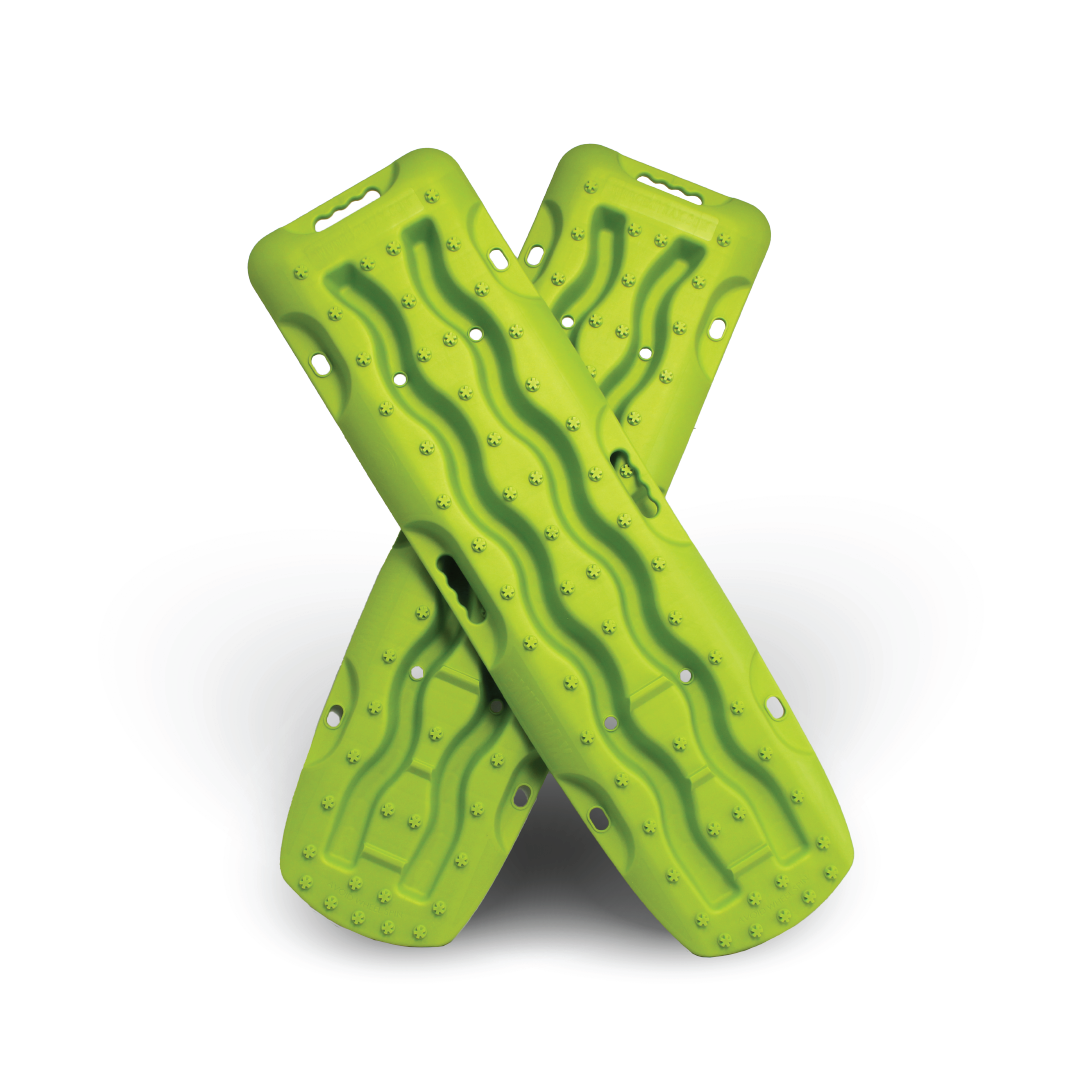 The Exitrax Recovery Board 1110 Series in Metallic Lime Green, sold as a pair by Exitrax, features an "X" shaped legged design. The boards are equipped with wave-like ridges and holes on each end to provide excellent grip and prevent wheel spin. Set against a white background with a soft shadow below, these durable boards offer peace of mind with a lifetime warranty.
