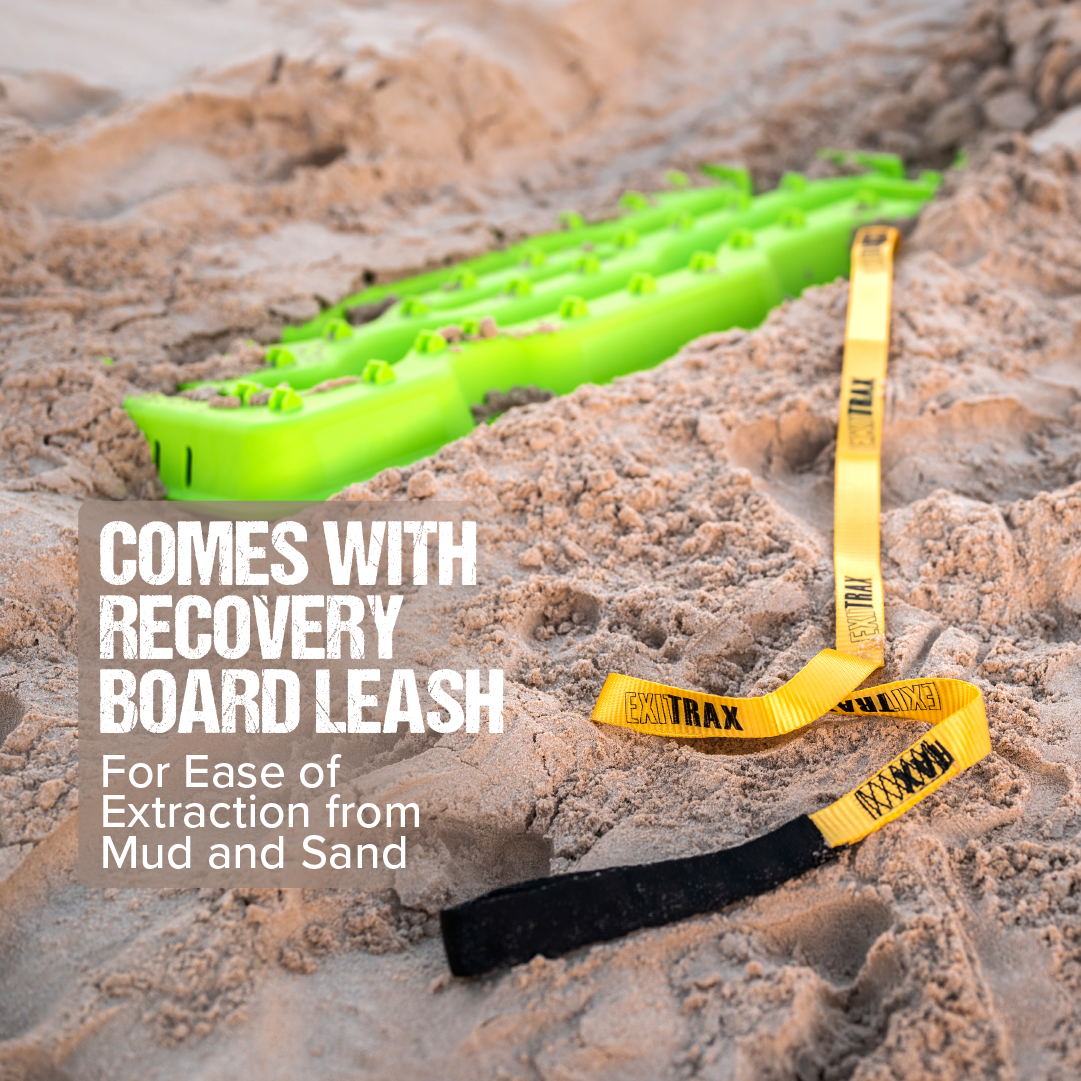 An Exitrax Recovery Boards 1110 Series - Metallic Lime Green + Mounts Bundle lies partially buried in sand, attached to a yellow and black leash. Includes recovery board leash for easy extraction from mud and sand. Lifetime Warranty.