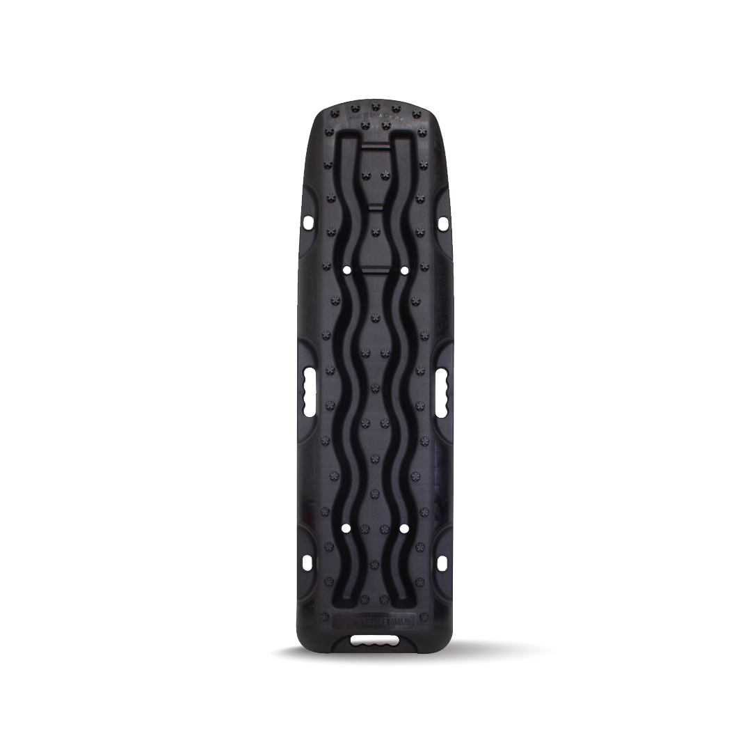 The Exitrax Recovery Board 1110 Series - Black, Pair (Trade Show Only) are rectangular traction boards specifically designed for off-road vehicle recovery. These black boards feature a wavy pattern and protruding knobs to enhance traction, providing superior grip. Side handles make them easy to carry and position. Exitrax stands behind their product with a Lifetime Warranty.