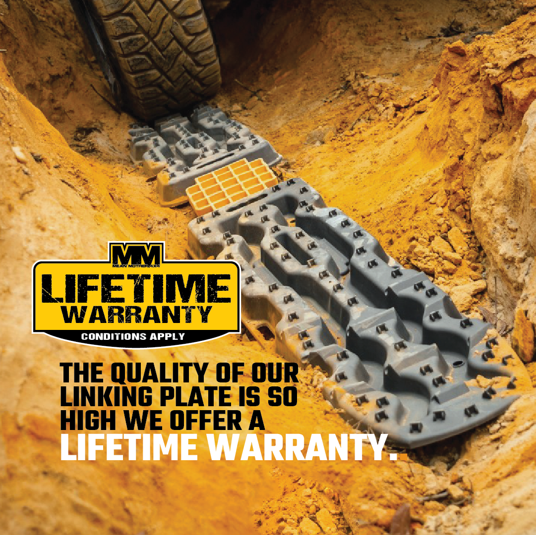 A linking plate track lies on a dirt surface. Text on the image reads, "The quality of our Exitrax Recovery Board Link Plate / Jack Base | Exilink is so high we offer a lifetime warranty." A yellow and black logo states, "Lifetime Warranty," with smaller text underneath, "Conditions apply.
