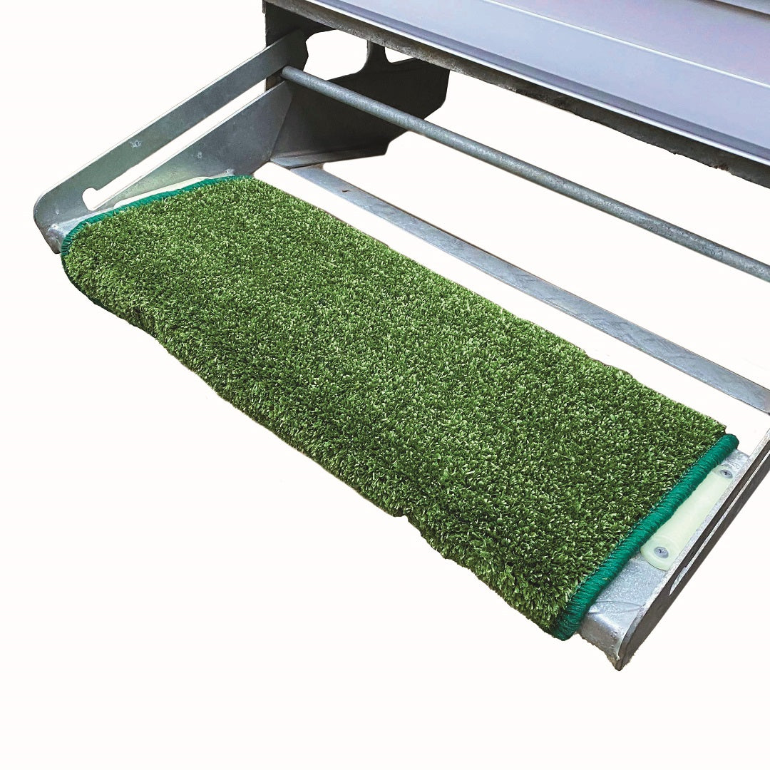 A close-up of the Explore Caravan Step Mat - Green attached to a metal stair. This hard-wearing, non-slip material provides cushioning and enhances safety and comfort on the metal surface, making it an ideal choice for secure footing.