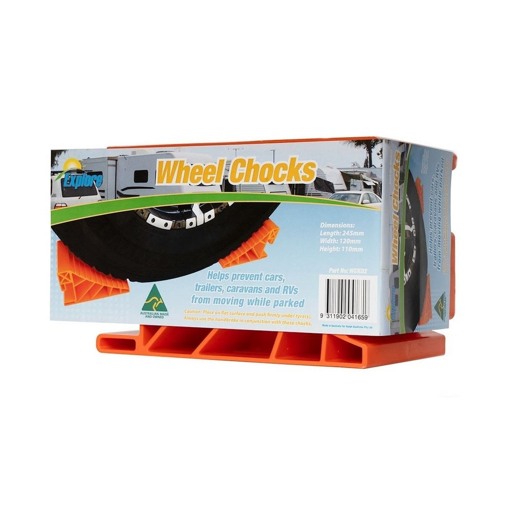 A box of Explore Wheel Chocks, designed for high visibility in orange, is shown on a white background. The packaging features an image of a secured wheel and provides dimensions and usage instructions for cars, trailers, caravans, and RVs.