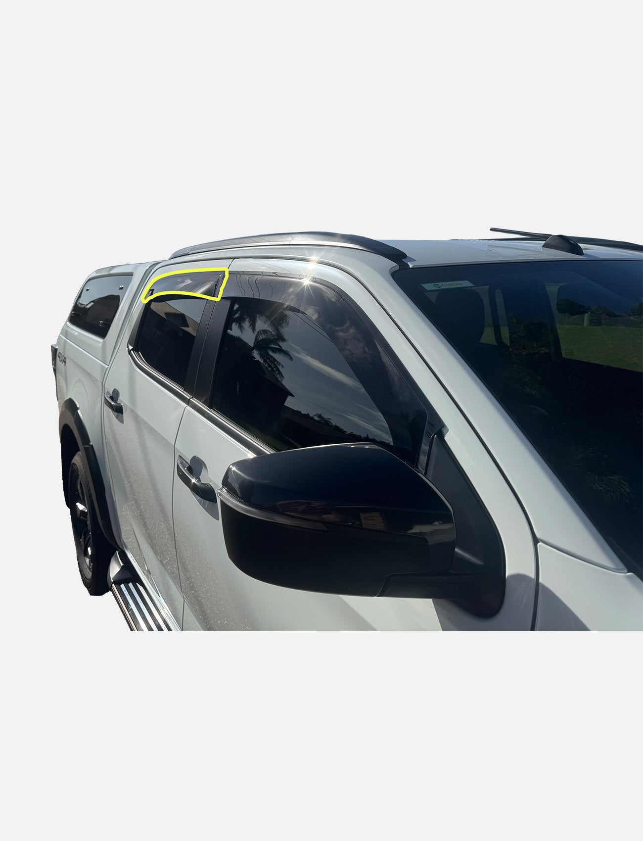 A white Isuzu D-Max RG Dual Cab (09/2020-on) with a Sunland Protective Plastics Weathershield Slimline Rear Driver (dark tint), tinted windows, a canopy, and a yellow outline on the front left visor is parked outside on a sunny day.