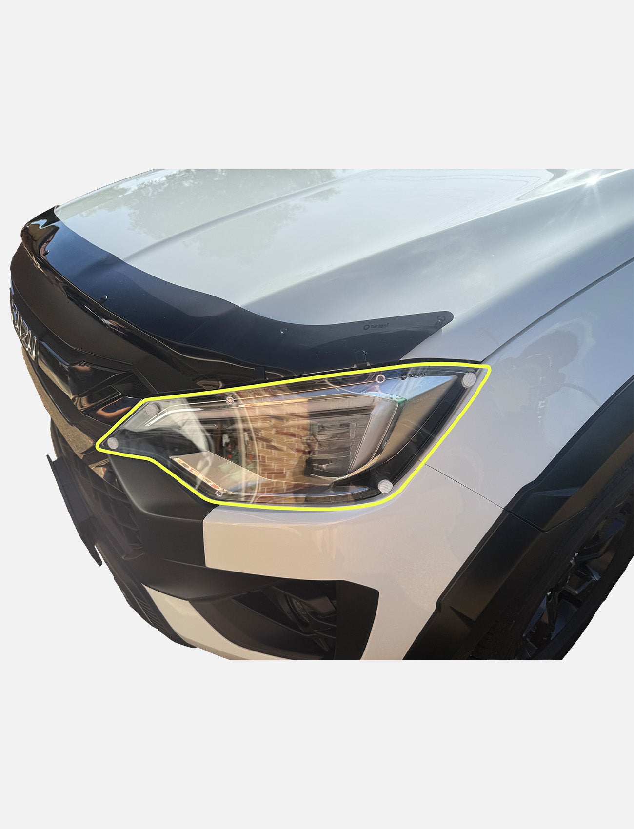 Close-up of the front left headlight of a white car with a black hood guard and yellow outline, fitted with Sunland Protective Plastics Isuzu D-Max Headlight Protectors (2 Piece, 04/2024-On, I150H) made from UV stable durable acrylic.
