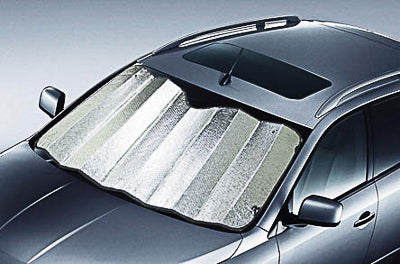 A car equipped with the Sunland-Protection Car Sun Shade (150cm x 85cm Silver) uses its reflective, metallic air bubble insulation to shield the windshield in a sunny setting, reducing interior heat. The vehicle also includes a sunroof for additional comfort.