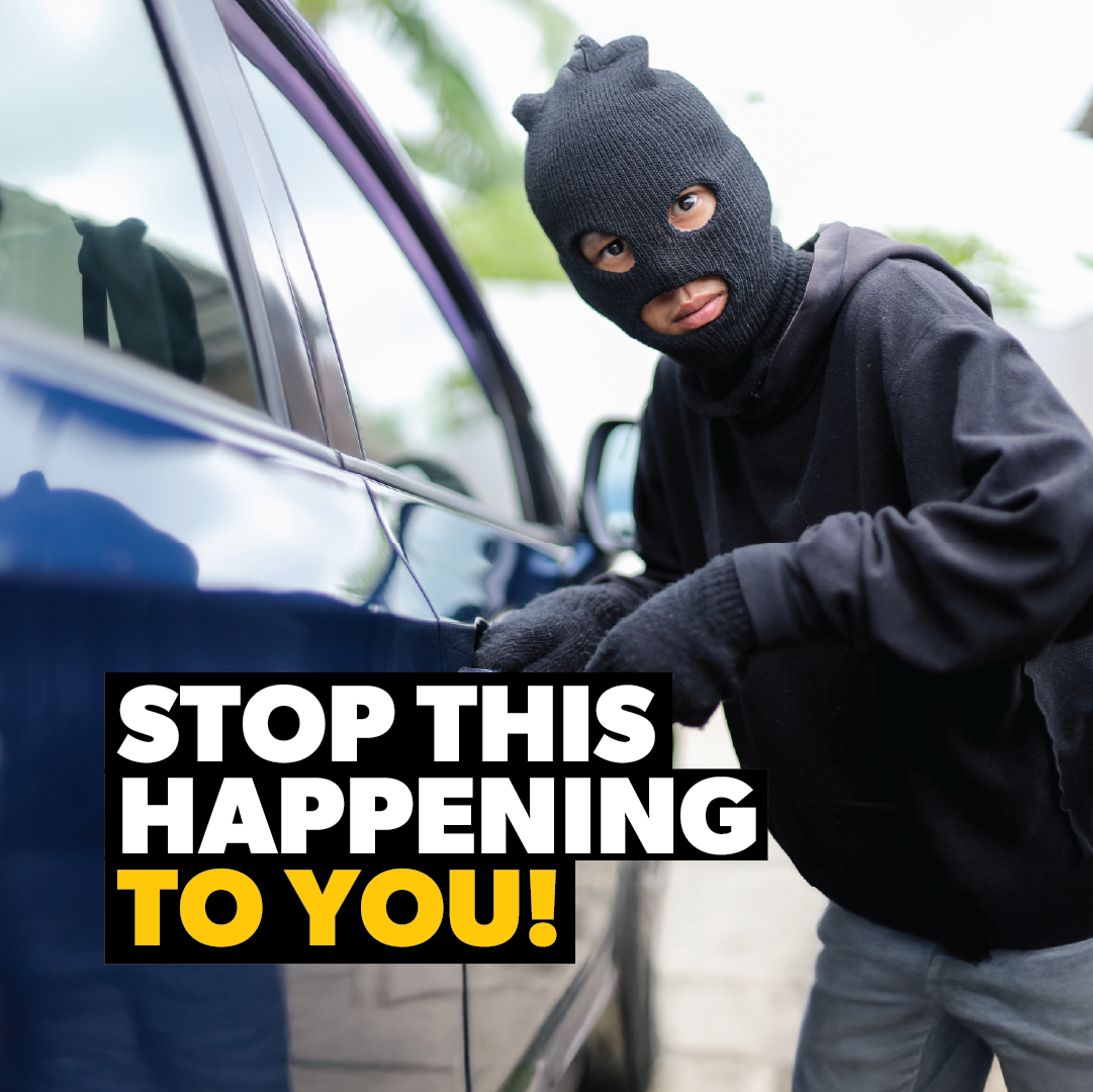 A person in a black ski mask and gloves tries to break into a car. Bold text says, “STOP THIS HAPPENING TO YOU!” Safeguard your vehicle with the Sperling Steering Wheel Lock Prolock or another anti-theft device.