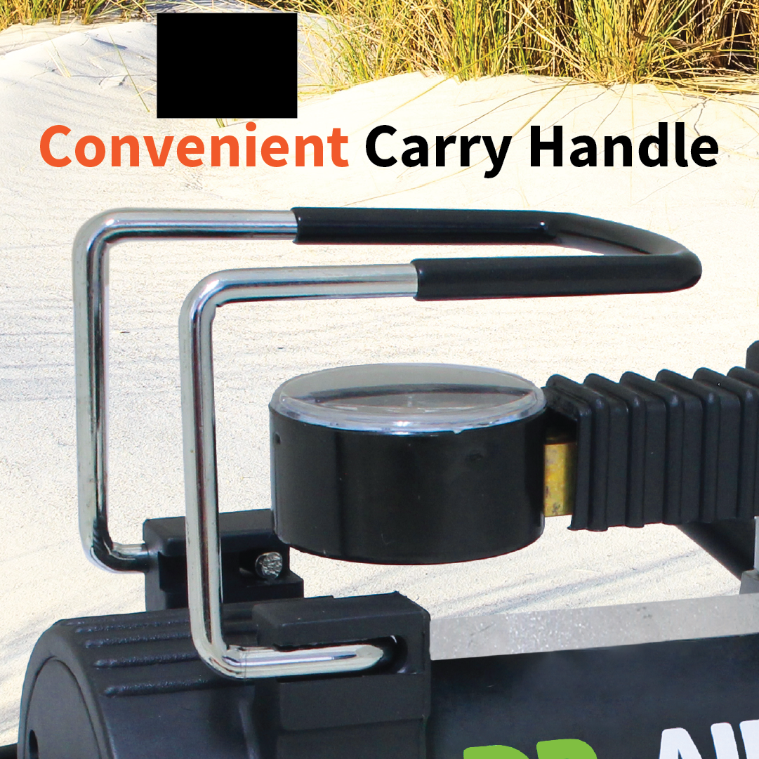 A close-up showcases the metallic carry handle on the Dr Air 12V Air Compressor 45 Lpm, featuring a circular lens with orange and black text above that reads "Convenient Carry Handle." The sandy terrain with grass in the background emphasizes that this reliable air compressor is ideal for on-the-go tasks.