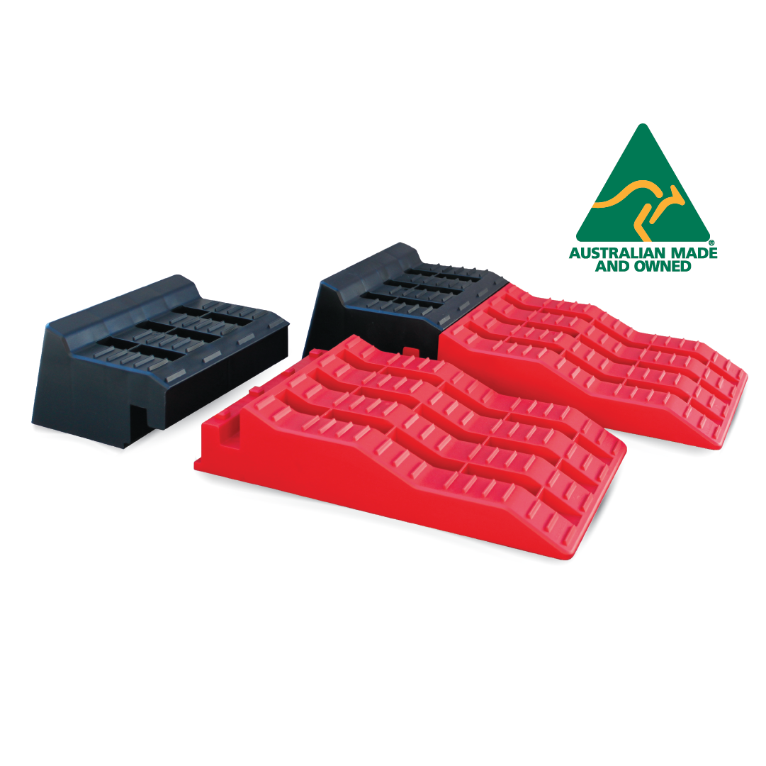 Explore's Caravan Levelling Ramps are crafted in red and black plastic for vehicles with tandem axles, available in various sizes. They feature a patented locking design and textured surfaces to ensure grip. The top right corner proudly displays a green and yellow "Australian Made and Owned" logo.