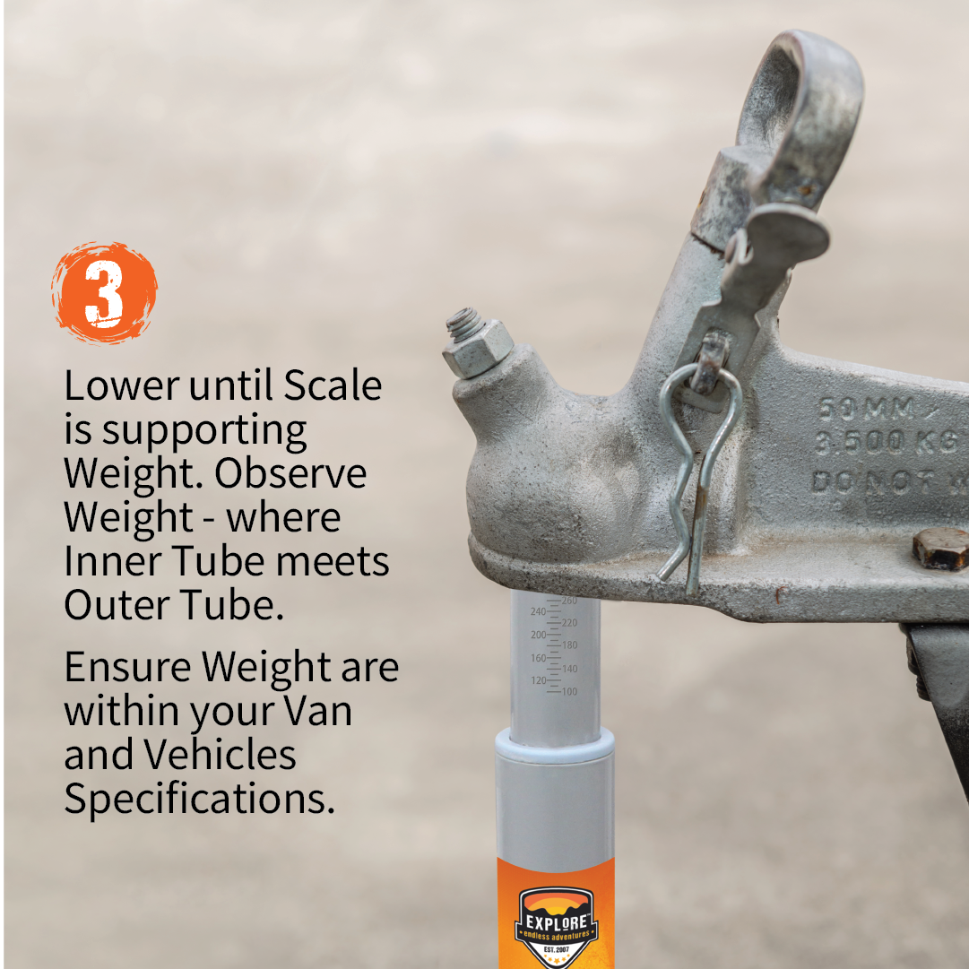 A close-up of a vehicle hitch features an instructional message for the **Explore Tow Ball Weight Scale** by **Explore**. The image displays the Tow Ball Weight Scale supporting an inner tube, annotated with measurements. The accompanying text reads: "3. Lower until the scale is supporting the weight. Observe the weight where the inner tube meets the outer tube to ensure caravan weight safety. Verify that the weight is within your van and vehicle's specifications.