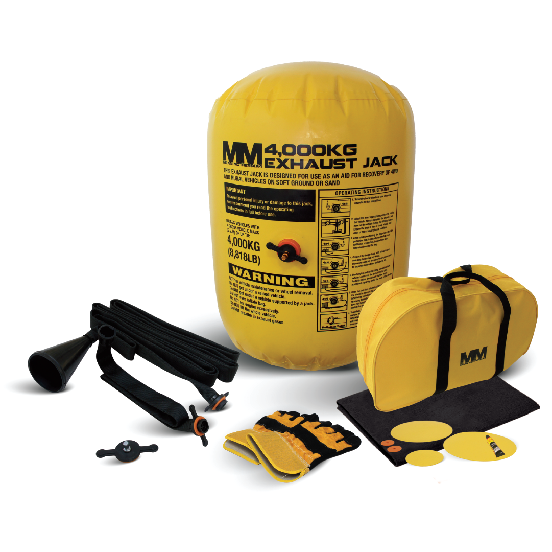 The image features the Mean Mother Exhaust / Air Jack 4000kg kit, an excellent solution for off-road recovery. The kit includes an inflatable yellow air jack, a black hose, an inflation valve, a black protective mat, round deflation tools, a yellow storage bag, and a pair of work gloves. This jack is specifically designed for vehicle lifting.