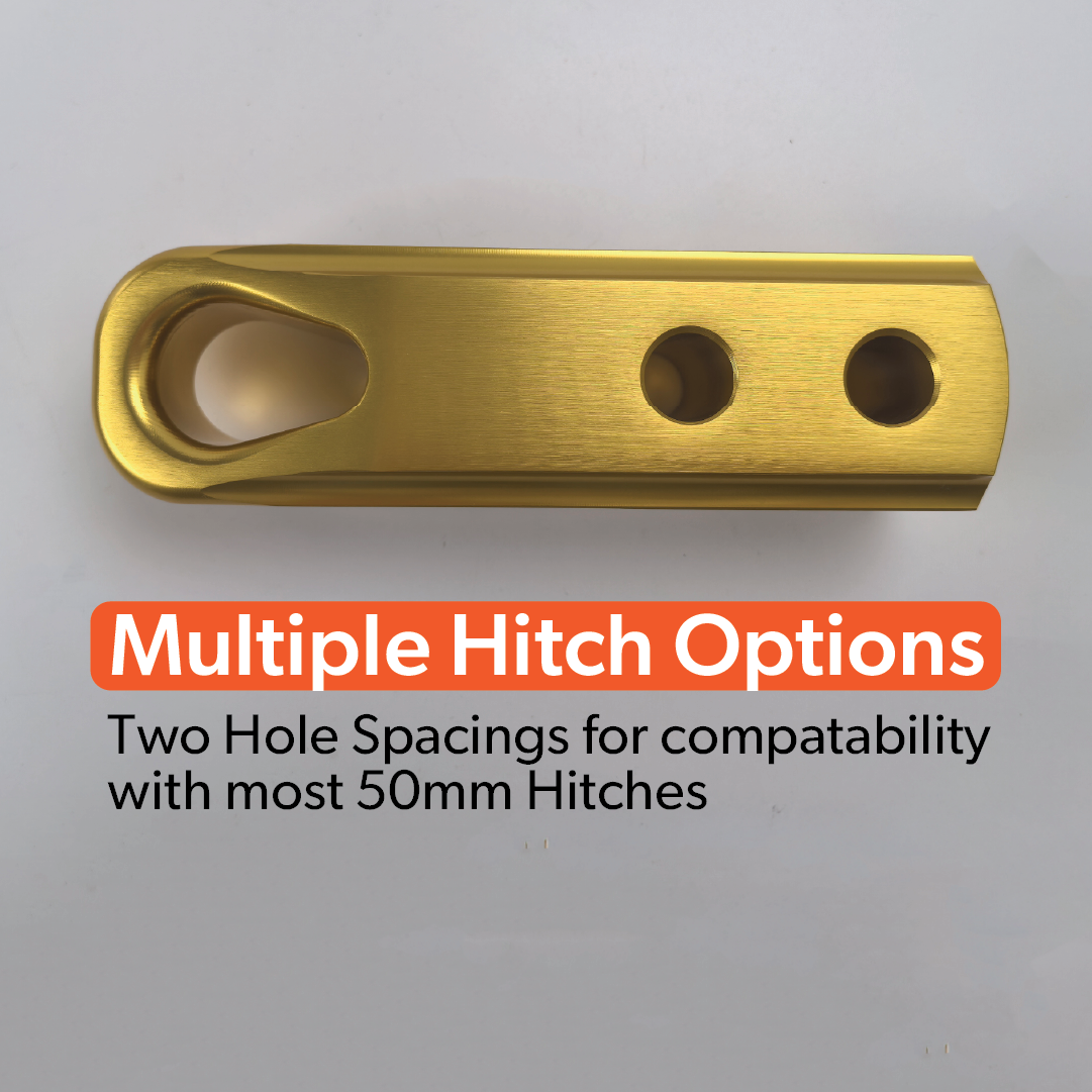 The Mean Mother 4x4 Recovery Hitch, made from gold-colored billet aluminium with three holes, is displayed on a gray background. Text: "Multiple Hitch Options. Two hole spacings for most 50mm tow hitch receivers.