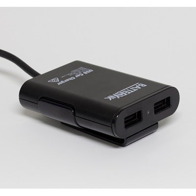 A sophisticated black USB car charger, known as the "Battery Link 4 Port USB Car Charger," offers four USB ports to power your devices. This compact 12V cigarette lighter adapter elegantly rests on a white surface, positioned for convenient use while traveling.