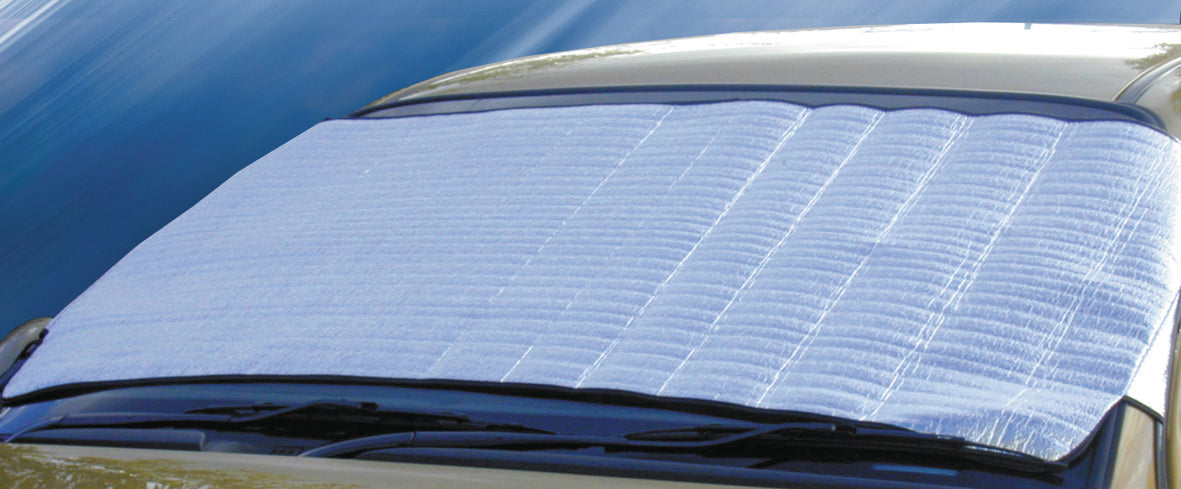 The Sunland-Protection Car Sun Shade, measuring 180cm x 70cm in silver, covers a beige car's windshield for UV protection by reflecting sunlight to keep the interior cool. Its textured surface and black border are in focus against a blurred background.